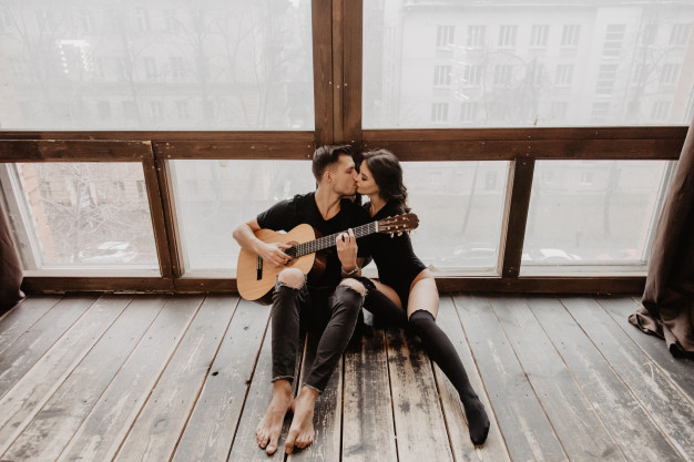 femme et homme guitare s'embrassent